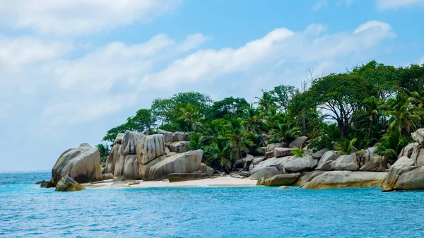 white tropical beach with huge boulders and palm trees Coco Island Tropical Seychelles Islands. 