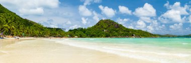 white tropical beach with turquoise colored ocean Anse Volbert beach Praslin Tropical Seychelles Islands. Cote Dor beach clipart