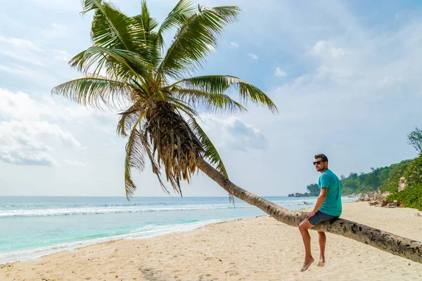 Young Men Relaxing Palm Tree Tropical White Beach Digue Seychelles — Stockfoto