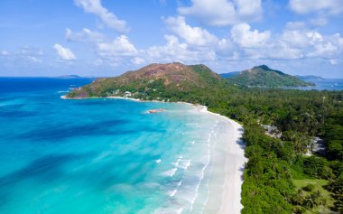 Drone view from above at a tropical beach in Seychelles. Anse Volbert beach Praslin with granite boulders rocks
