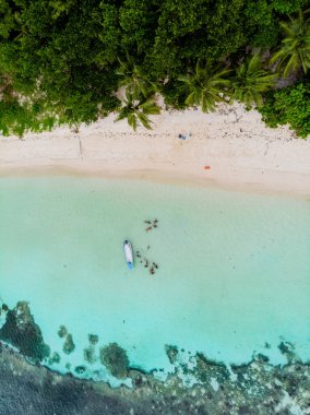 Drone view from above at a tropical beach in Seychelles. Anse Volbert beach Praslin with granite boulders rocks
