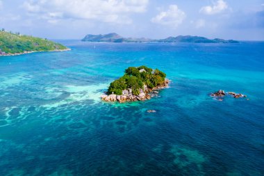 Drone view from above at a tropical beach in Seychelles. Anse Volbert beach Praslin with granite boulders rocks