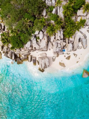 Drone view from above at a tropical beach in the Seychelles Cocos Island.