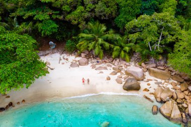 Drone view from above at Anse Lazio beach Praslin Island Seychelles. a couple of men and women on the beach