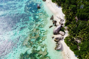 Drone view from above at a tropical white beach in the Seychelles, Anse Source dArgent white tropical beach with huge granite boulders at La Digue Island