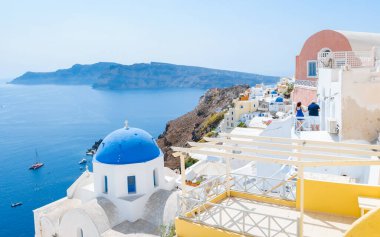Oia Santorini Greece on a sunny day during summer with whitewashed homes and churches, Greek Island Aegean Cyclades