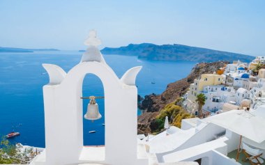 Oia Santorini Greece on a sunny day during summer with whitewashed homes and churches, Greek Island Aegean Cyclades on a sunny day with blue ocean