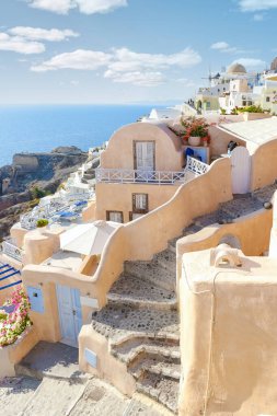 streets of the village of Oia Santorini Greece on a sunny day during summer with whitewashed homes and churches, Greek Island Aegean Cyclades