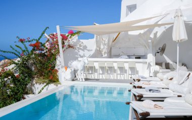Vacation at Santorini swimming pool looking out over the Caldera ocean of Santorini, Oia Greece, Greek Island Aegean Cyclades September 2017