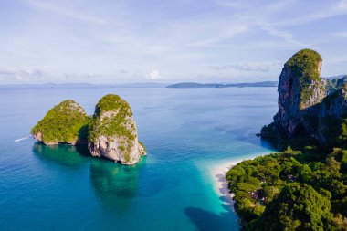 Railay Beach Krabi Thailand, the tropical beach of Railay Krabi, drone view from above, Panoramic view of idyllic Railay Beach in Thailand with a traditional long boat.