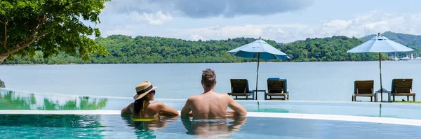 Young Couple Men Women Swimming Pool Vacation Tropical Island Man — Stock fotografie