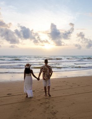 Railay Beach Krabi Thailand, the tropical beach of Railay Krabi, a couple of men and women on the beach, Panoramic view of idyllic Railay Beach in Thailand at sunset