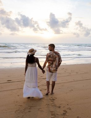 Railay Beach Krabi Thailand, the tropical beach of Railay Krabi, a couple of men and women on the beach, Panoramic view of idyllic Railay Beach in Thailand at sunset