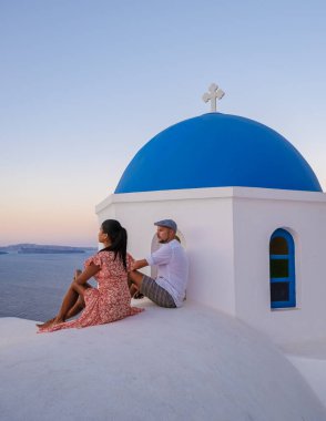 Couple on vacation in Santorini Greece, men, and women on the streets of the Greek village of Oia Santorini
