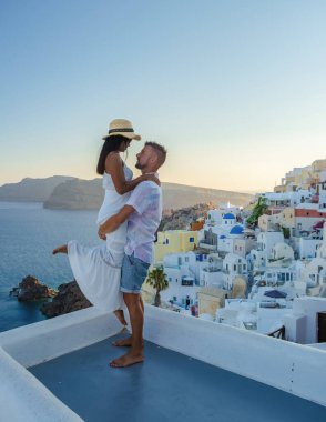 Couple on vacation in Santorini Greece, men, and women on the streets of the Greek village of Oia Santorini