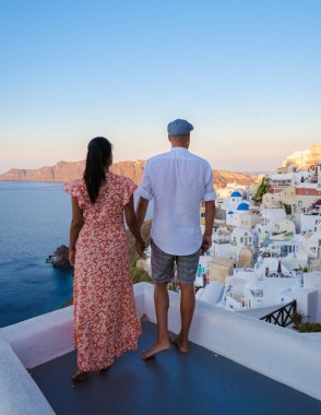 Couple on vacation in Santorini Greece, men, and women on the streets of the Greek village of Oia Santorini