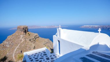 Fira, Santorini island, Greece: Traditional and famous white houses over the Caldera, Aegean sea. white church at the ocean