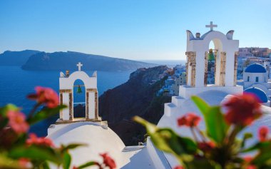 sunset with white churches an blue domes by the ocean of Oia Santorini Greece, a traditional Greek village in Santorini. 