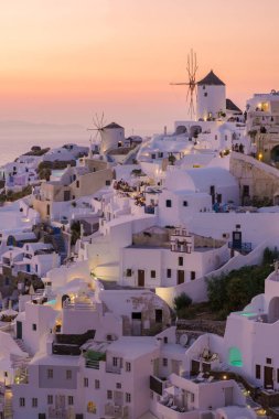 White churches an blue domes by the ocean of Oia Santorini Greece, a traditional Greek village in Santorini during summer
