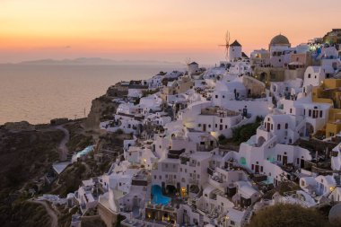 White churches an blue domes by the ocean of Oia Santorini Greece, a traditional Greek village in Santorini during summer