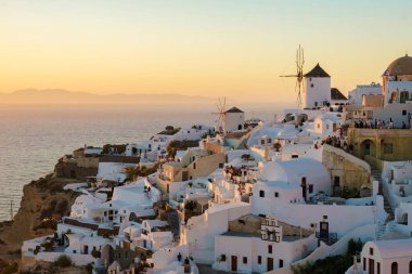 sunset by the ocean of Oia Santorini Greece, a traditional Greek village in Santorini with whitewashed churches and blue domes