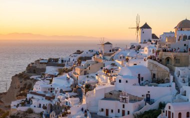 White churches and blue domes by the ocean of Oia Santorini Greece, a traditional Greek village in Santorini in the evening light