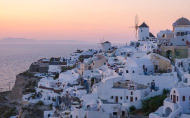 White churches an blue domes by the ocean of Oia Santorini Greece, a traditional Greek village in Santorini during summer