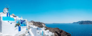 White churches an blue domes by the ocean of Oia Santorini Greece, a traditional Greek village in Santorini during summer