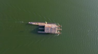 Huai Krathing lake in North Eastern Thailand Isaan region is famous for its floating bamboo rafts where you can have lunch or dinner in the middle of the lake with Thai food