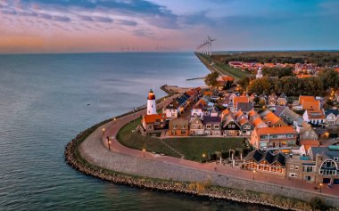 Urk Flevoland Netherlands sunset at the lighthouse and harbor of Urk Holland. Traditional Fishing village Urk. Beautiful sunset during the evening
