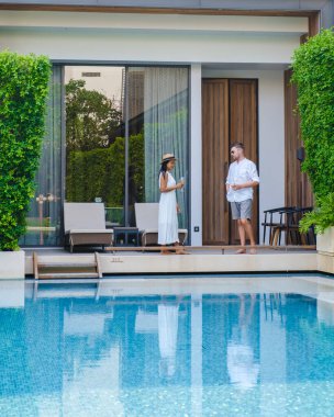 Asya 'da lüks 5 yıldızlı otel havuzu. Lüks bir otelde tatil yapan bir çift kadın ve erkek, havuz başında kadınlar ve erkekler.