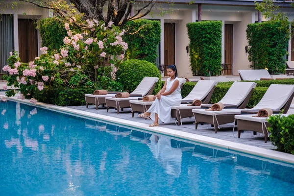 Asian women relaxing at a Luxury 5 star hotel pool in Asia.
