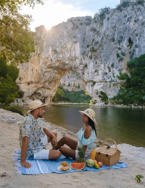 stock image couple having picnic on the beach on vacation in the Ardeche France Pont d Arc, Ardeche France, view of Natural arch in Vallon Pont dArc in Ardeche canyon in France Europe Rhone Alps Dordogne