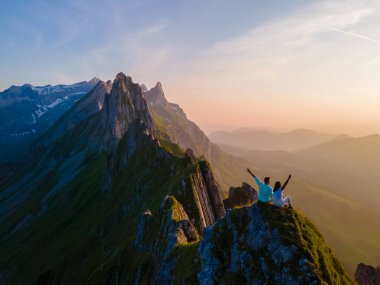 Schaeffler dağ sırtı İsviçreli Alpstein, Appenzell İsviçre, Berggasthaus Schafler, İsviçre 'nin görkemli Schaeffler zirvesinin bir sırtı. Gün batımında dağlarda bir çift erkek ve kadın.