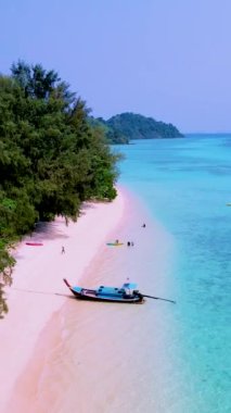 Kumsalda uzun kuyruklu tekneleri ve güneşli bir günde turkuaz renkli bir okyanusu olan Koh Kradan Adası Güney Tayland