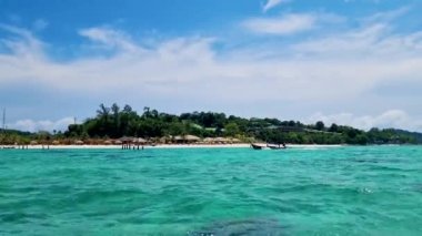 Güneşli bir günde Tayland 'daki Koh Lipe Adası' nda turkuaz renkli okyanusun hava manzarası. Yaz boyunca kumsalda kumlu ve mavi okyanuslu İHA hava manzarası