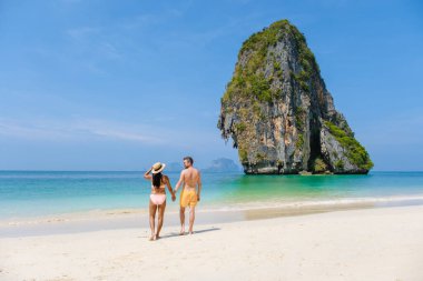 Railay Beach Krabi Thailand, the tropical beach of Railay Krabi, a couple of men and women on the beach, Panoramic view of idyllic Railay Beach in Thailand