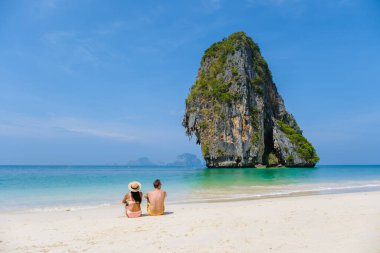 Railay Beach Krabi Thailand, the tropical beach of Railay Krabi, a couple of men and women on the beach, Panoramic view of idyllic Railay Beach in Thailand