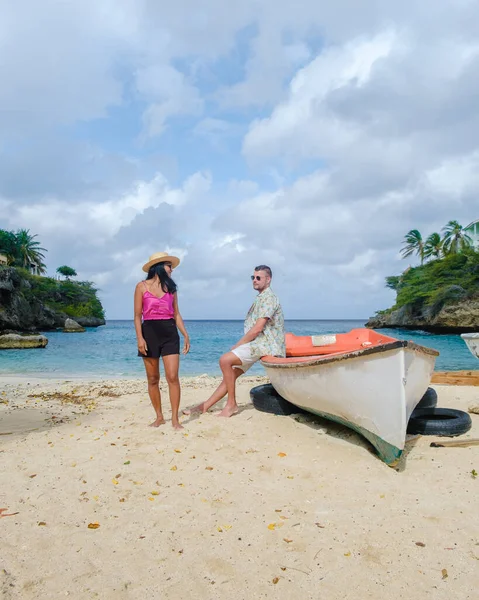 stock image A couple of men and women in swimshorts and bikinis at Playa Lagun Beach Cliff Curacao, 