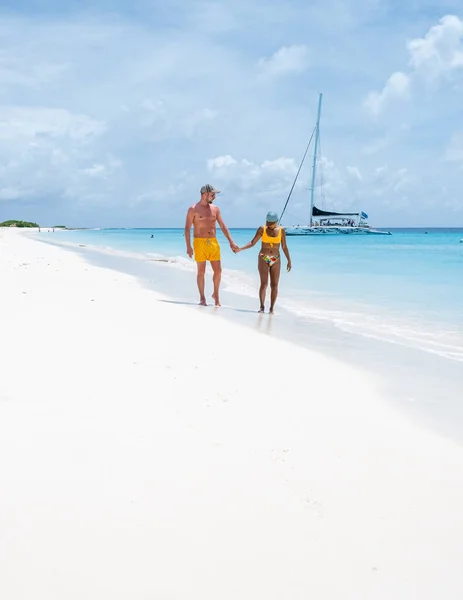 カリブ海の熱帯ビーチを持つクラインキュラソー島カラカオ島 白いビーチとターコイズブルーの海を持つ小さなキュラソー島へのボート旅行中の男性と女性のカップル — ストック写真