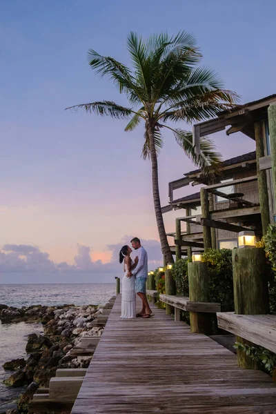 カリブ海での休暇中にキュラソーのビーチでカップル 男性と女性はキュラソーの熱帯ビーチで夕日を見ています — ストック写真