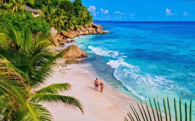 Anse Patates beach, La Digue Island, Seyshelles, Drone aerial view of La Digue Seychelles bird eye view.of tropical Island. mature couple men and women on vacation in Seychelles clipart