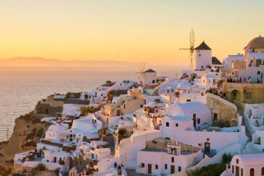 White churches an blue domes by the ocean of Oia Santorini Greece, a traditional Greek village in Santorini.