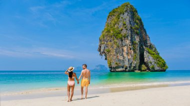 Railay Beach Krabi Thailand, the tropical beach of Railay Krabi, a couple of men and women on the beach, Panoramic view of idyllic Railay Beach in Thailand