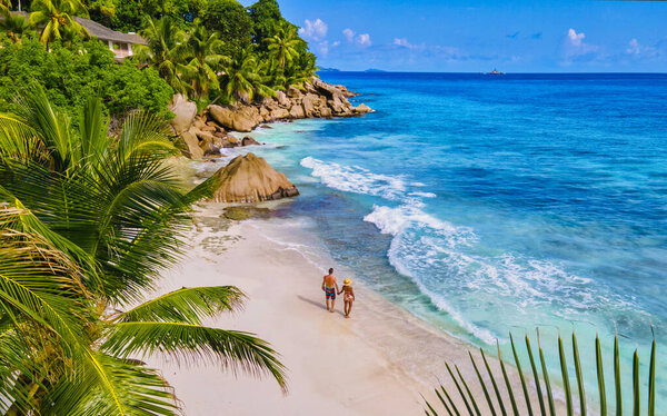 Anse Patates beach, La Digue Island, Seyshelles, Drone aerial view of La Digue Seychelles bird eye view.of tropical Island. mature couple men and women on vacation in Seychelles