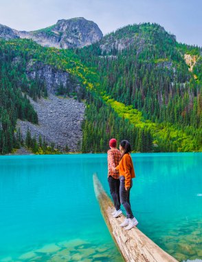 Joffre Lakes British Colombia Whistler Canada, colorful lake of Joffre lakes national park in Canada. Couple of Asian women and caucasian men walking at Jofre Lake BC Canada