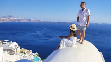 Couple on vacation in Santorini Greece, men, and women on the streets of the Greek village of Oia Santorini