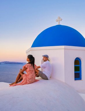 Couple on vacation in Santorini Greece, men, and women on the streets of the Greek village of Oia Santorini