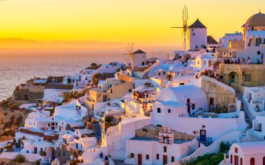 White churches and blue domes by the ocean of Oia Santorini Greece, a traditional Greek village in Santorini in the evening light