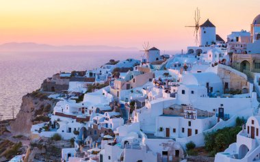 Sunset at the Greek village of Oia Santorini Greece with a view over the ocean caldera of Santorini